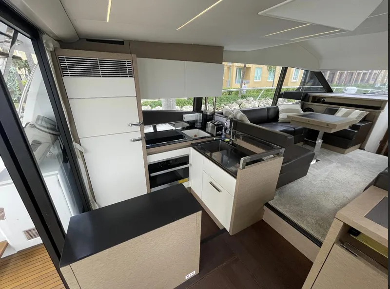 Slide: The Image of Luxurious interior of a 2018 Prestige 520 yacht with modern kitchen and seating area. - 12