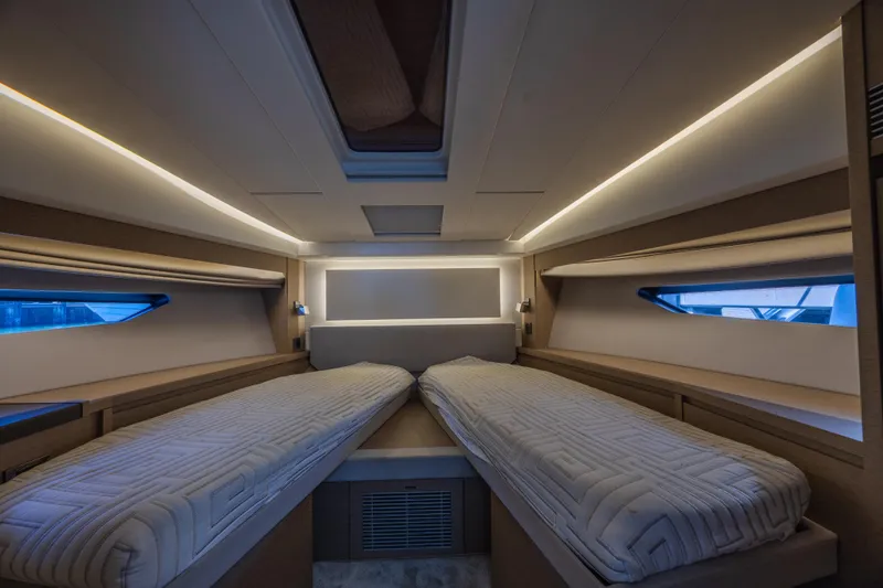 Slide: The Image of Luxurious interior cabin of a 2018 Prestige 520 yacht with twin beds and ambient lighting. - 20