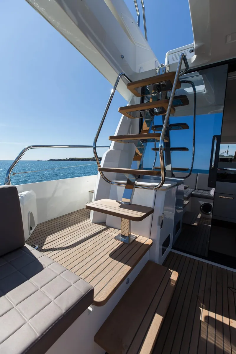 Slide: The Image of Prestige 520 yacht, 2018 model, featuring elegant wooden stairs and ocean view. - 24