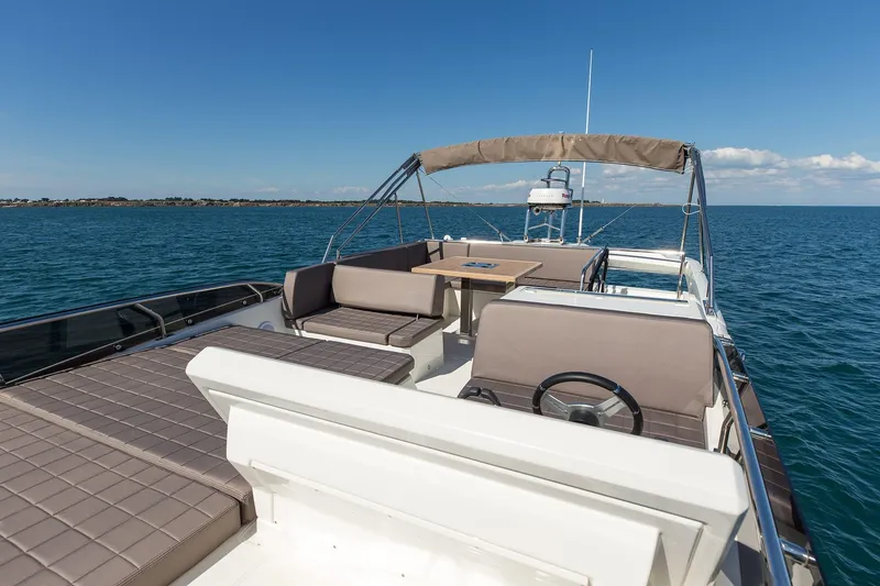 Slide: The Image of 2018 Prestige 520 yacht with spacious deck and seating on open water. - 25