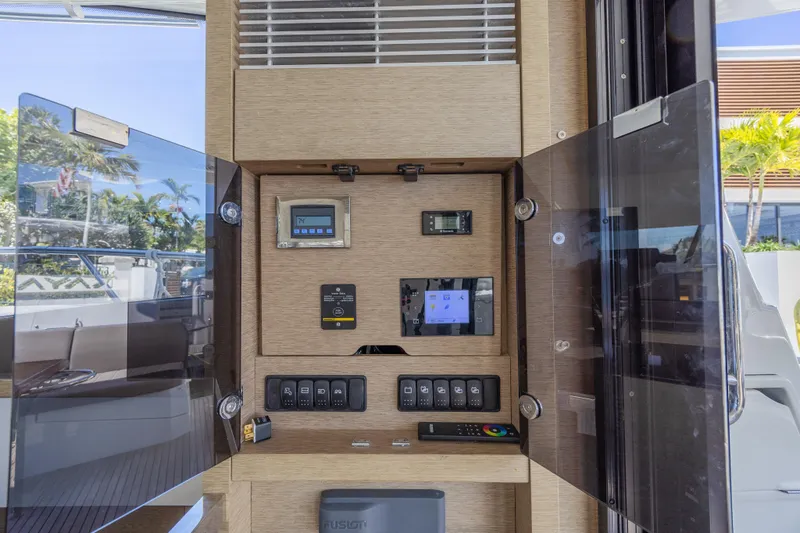 Slide: The Image of Control panel inside a 2018 Prestige 520 yacht, featuring various switches and displays. - 27