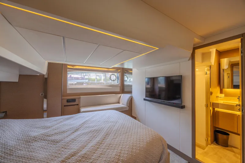Slide: The Image of Luxurious cabin interior of 2018 Prestige 520 yacht with bed, TV, and ensuite bathroom. - 30