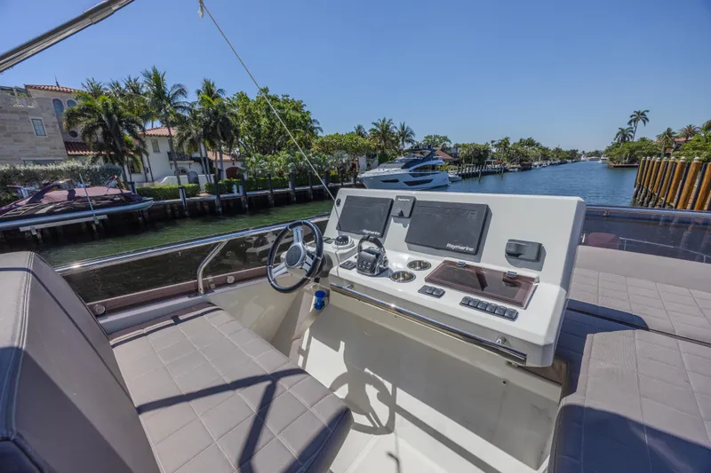 Slide: The Image of Prestige 520 yacht helm, 2018 model, with modern navigation equipment, cruising on a sunny waterway. - 38