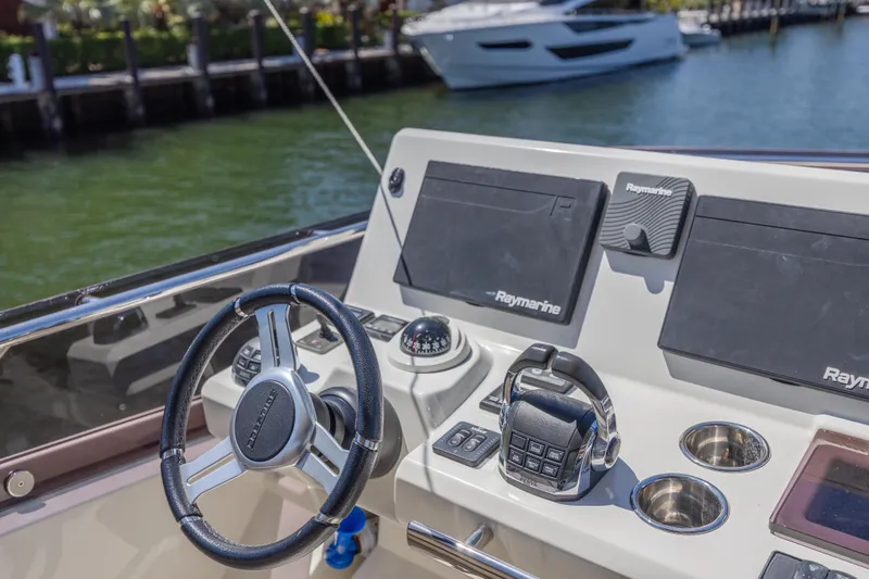 Slide: The Image of Helm of 2018 Prestige 520 yacht with Raymarine navigation system, docked by the water. - 40