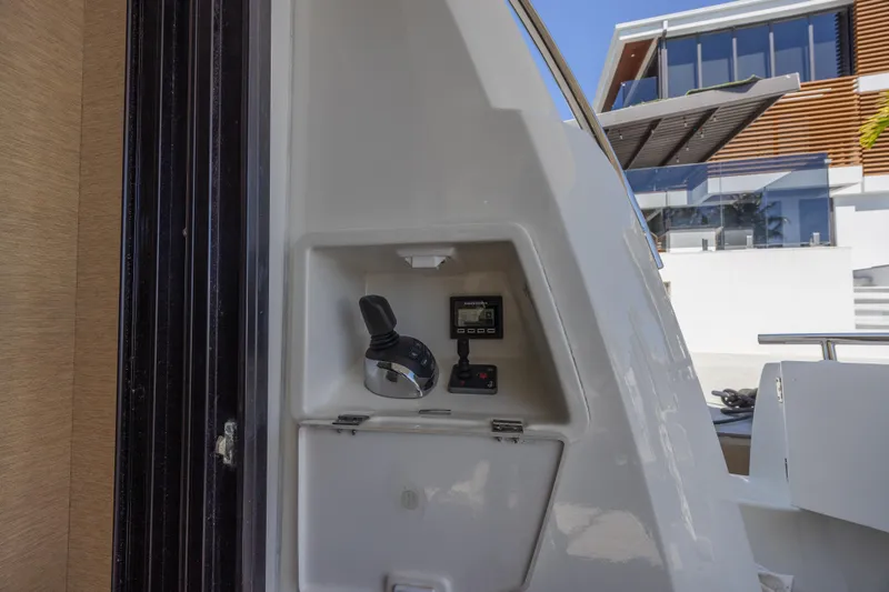 Slide: The Image of Control panel on a 2018 Prestige 520 yacht, with modern architecture in the background. - 42