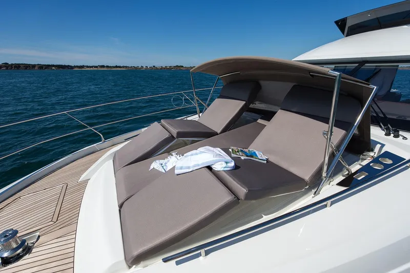 Slide: The Image of Luxury sun loungers on 2018 Prestige 520 yacht deck, overlooking serene ocean waters. - 45
