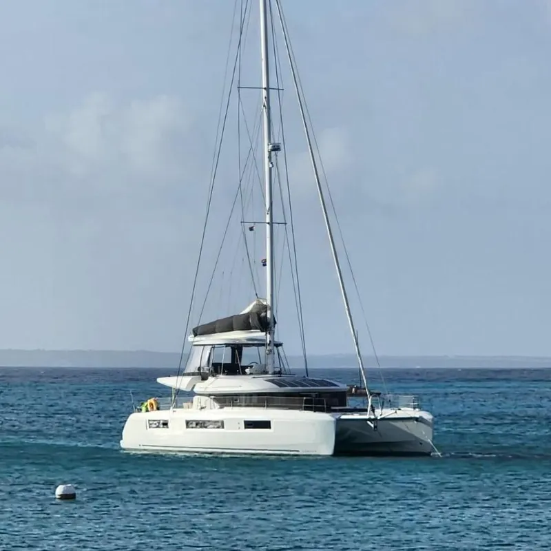 Slide: The Image of 2023 Lagoon 50 catamaran sailing on calm blue waters. - 0