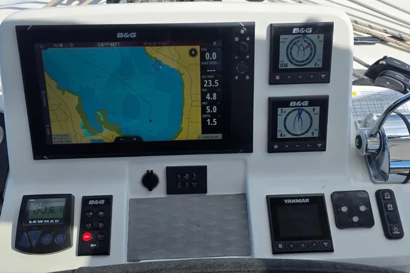 Slide: The Image of Control panel of a 2023 Lagoon 50 yacht with navigation and monitoring displays. - 12