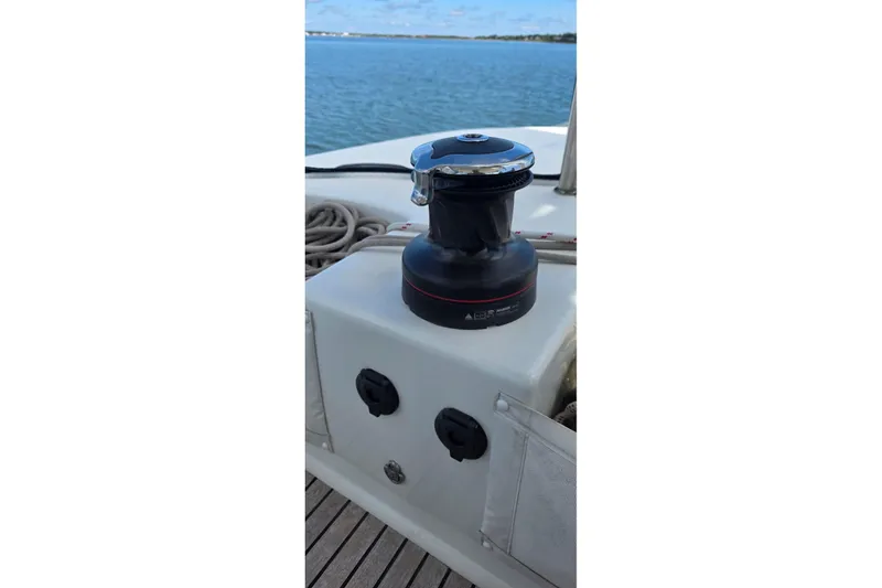 Slide: The Image of Winch on 2023 Lagoon 50 catamaran deck, overlooking calm blue waters. - 14