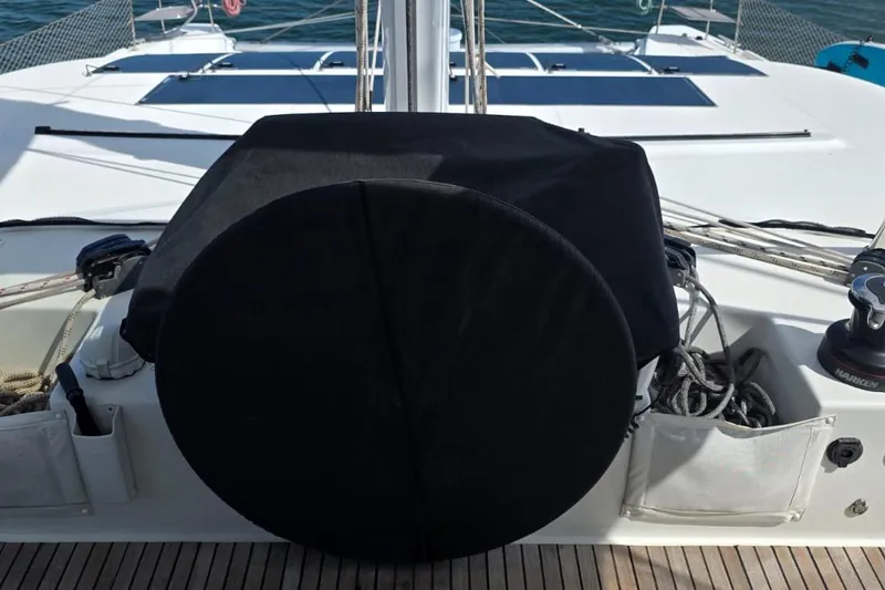 Slide: The Image of 2023 Lagoon 50 yacht deck with covered equipment and ropes. - 15