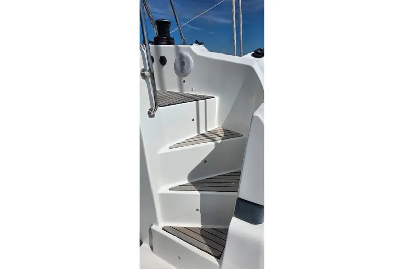 Slide: The Image of Staircase on 2023 Lagoon 50 yacht, featuring sleek design and wooden steps. - 16