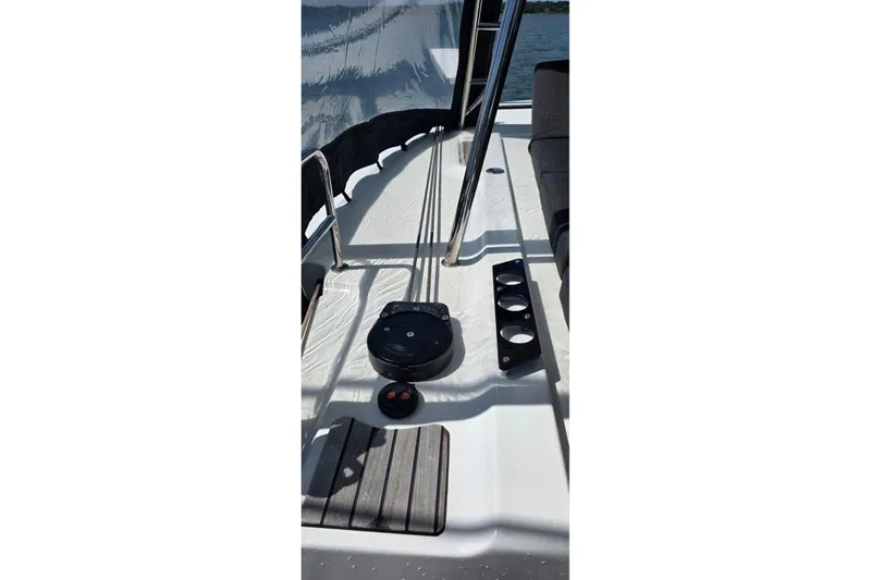 Slide: The Image of 2023 Lagoon 50 yacht deck with railing and equipment in sunlight. - 22