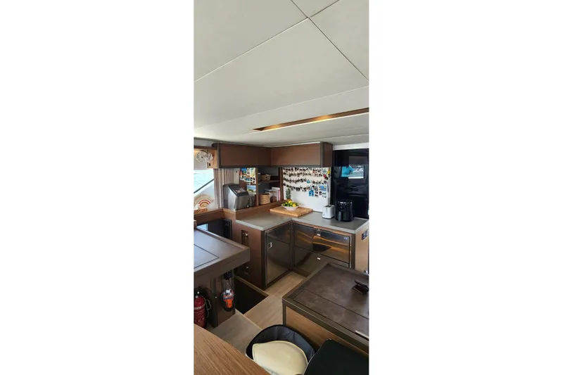 Slide: The Image of Interior of 2023 Lagoon 50 yacht kitchen with modern appliances and sleek design. - 26