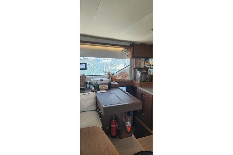 Slide: The Image of Interior of 2023 Lagoon 50 yacht with navigation desk and window view. - 27