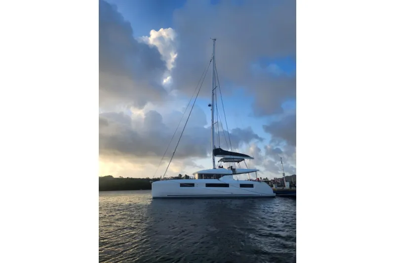 Slide: The Image of 2023 Lagoon 50 catamaran sailing at sunset with dramatic clouds. - 3