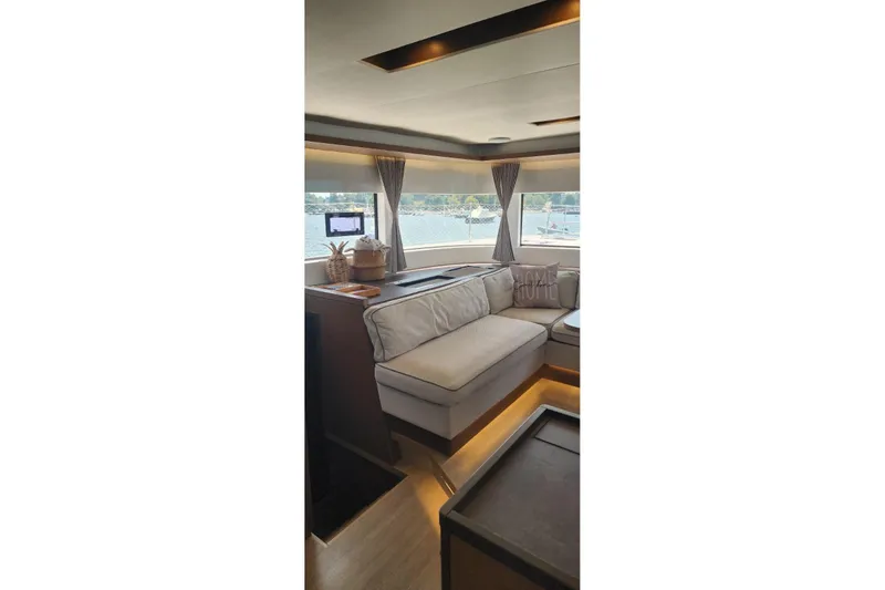 Slide: The Image of Luxurious interior of 2023 Lagoon 50 yacht with elegant seating and scenic window views. - 30