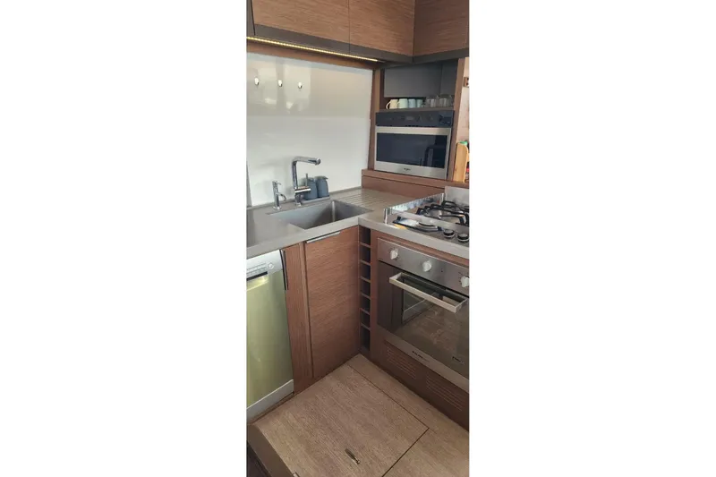 Slide: The Image of Modern kitchen in 2023 Lagoon 50 yacht with wood cabinetry and stainless steel appliances. - 38