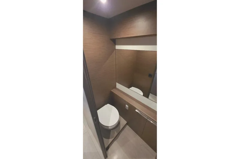 Slide: The Image of Modern bathroom interior in 2023 Lagoon 50 yacht, featuring sleek wood paneling and mirror. - 39