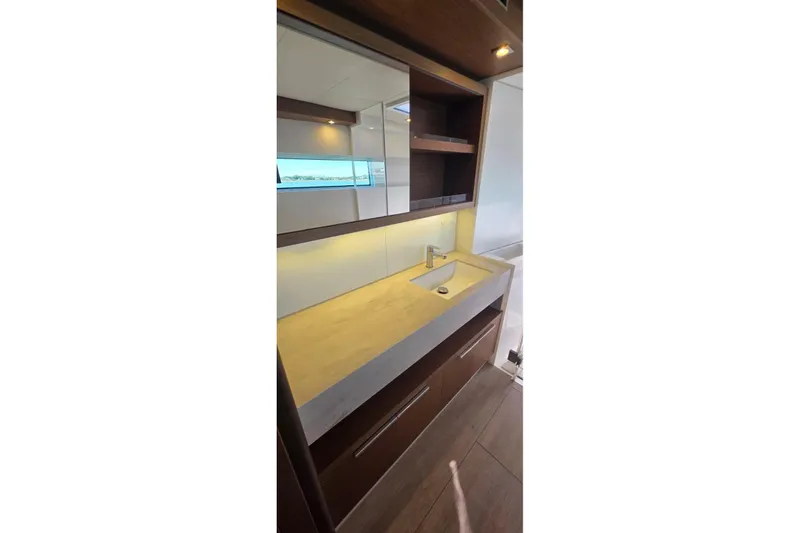 Slide: The Image of Modern bathroom interior on 2023 Lagoon 50 yacht, featuring sleek sink and wooden cabinetry. - 41