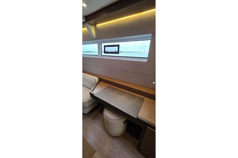 Slide: The Image of Interior of 2023 Lagoon 50 yacht with modern seating and window view. - 46