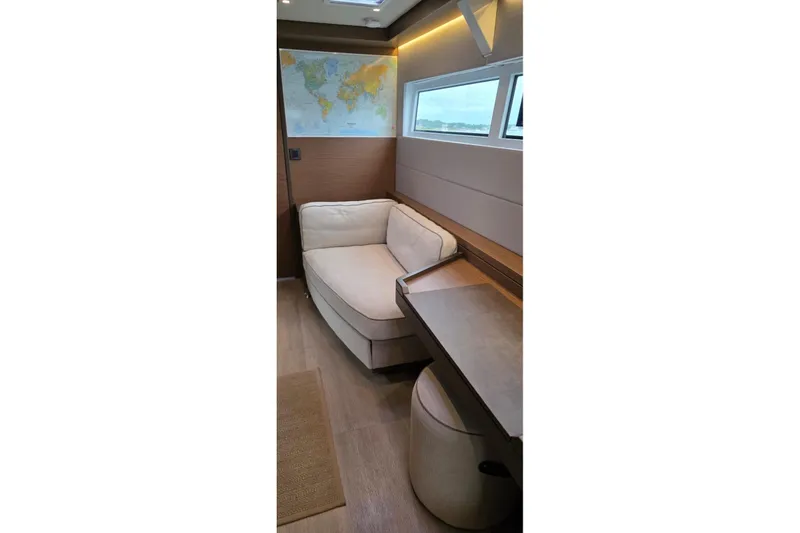Slide: The Image of Interior of 2023 Lagoon 50 yacht with cozy seating and world map decor. - 47