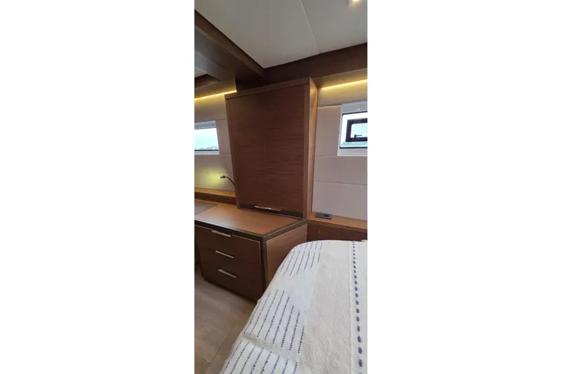 Slide: The Image of Interior cabin of 2023 Lagoon 50 yacht with wooden furnishings and modern design. - 50