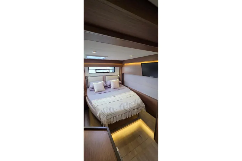 Slide: The Image of Luxurious bedroom interior of 2023 Lagoon 50 yacht with modern design and cozy ambiance. - 51