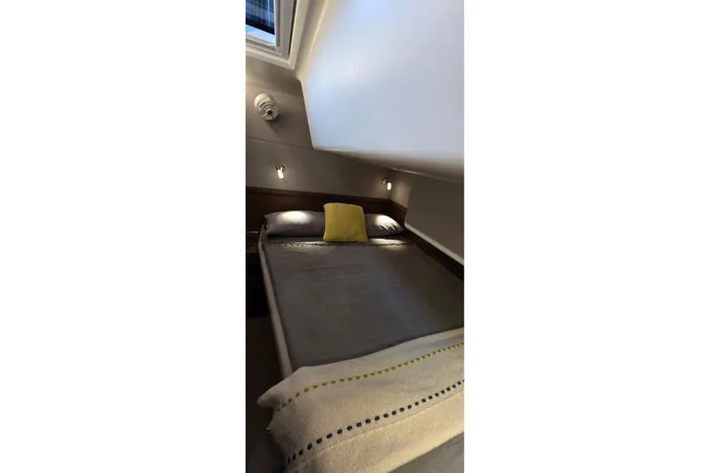 Slide: The Image of Cozy bedroom in 2023 Lagoon 50 yacht with skylight and modern decor. - 54
