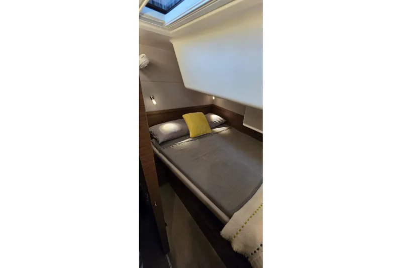Slide: The Image of Cozy bedroom interior of 2023 Lagoon 50 yacht with skylight and modern design. - 55