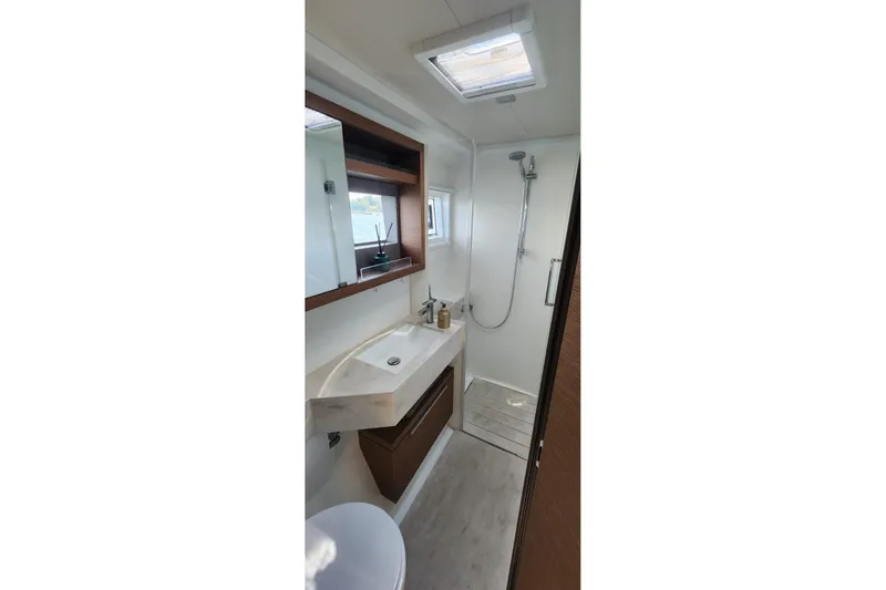 Slide: The Image of Modern bathroom in 2023 Lagoon 50 yacht with shower, sink, and mirror. - 58