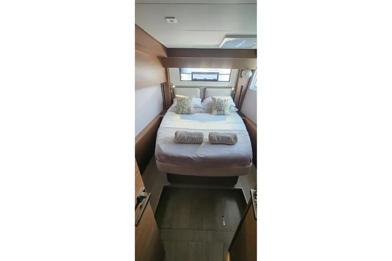 Slide: The Image of Luxurious bedroom interior of 2023 Lagoon 50 yacht with cozy bedding and natural light. - 62