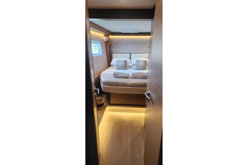 Slide: The Image of Luxurious cabin interior of 2023 Lagoon 50 yacht with cozy bed and ambient lighting. - 67