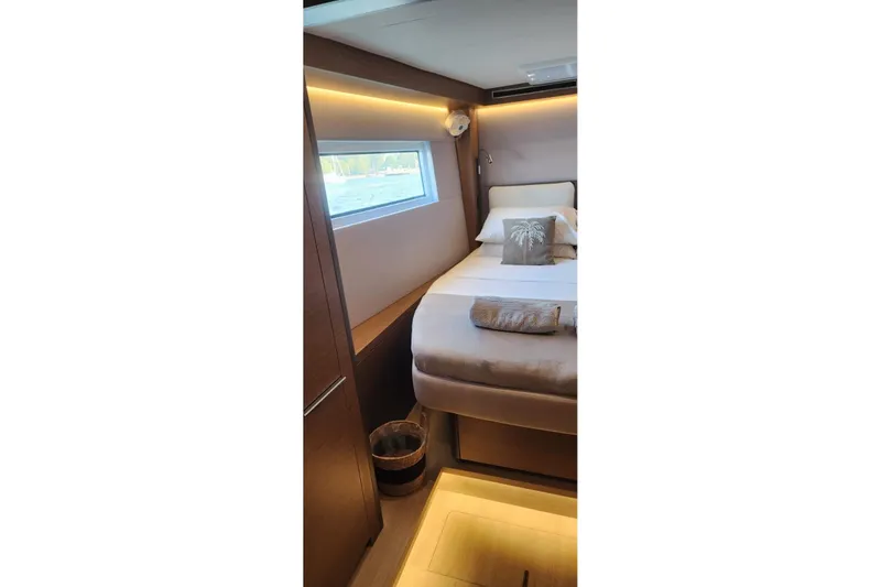 Slide: The Image of Luxurious cabin interior of 2023 Lagoon 50 yacht with modern design and cozy bedding. - 68