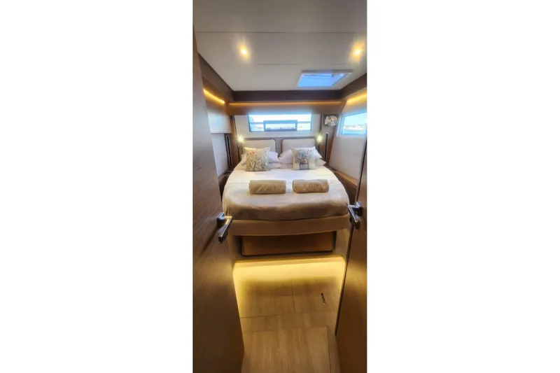Slide: The Image of Luxurious bedroom interior of 2023 Lagoon 50 yacht with modern lighting and cozy bedding. - 71