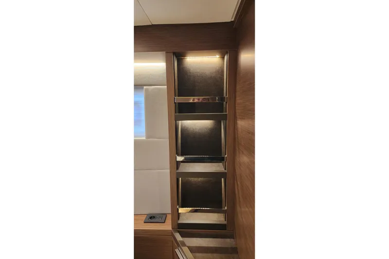 Slide: The Image of Interior shelving on 2023 Lagoon 50 yacht, featuring modern wood and metal design. - 76