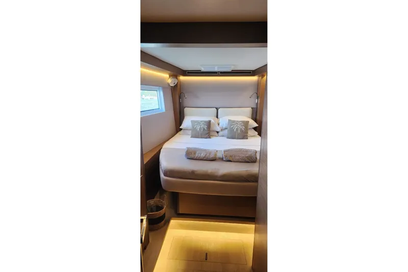 Slide: The Image of Luxurious bedroom interior of 2023 Lagoon 50 yacht with cozy bedding and ambient lighting. - 77