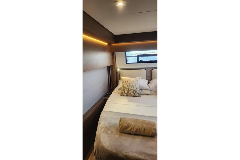 Slide: The Image of Luxurious bedroom interior of 2023 Lagoon 50 yacht with elegant bedding and ambient lighting. - 78