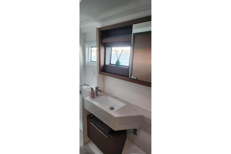 Slide: The Image of Modern bathroom interior on 2023 Lagoon 50 yacht with sink and window view. - 79