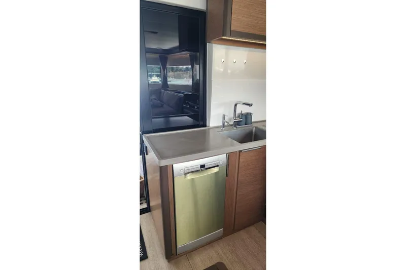 Slide: The Image of Modern kitchen interior of 2023 Lagoon 50 yacht with stainless steel sink and dishwasher. - 80