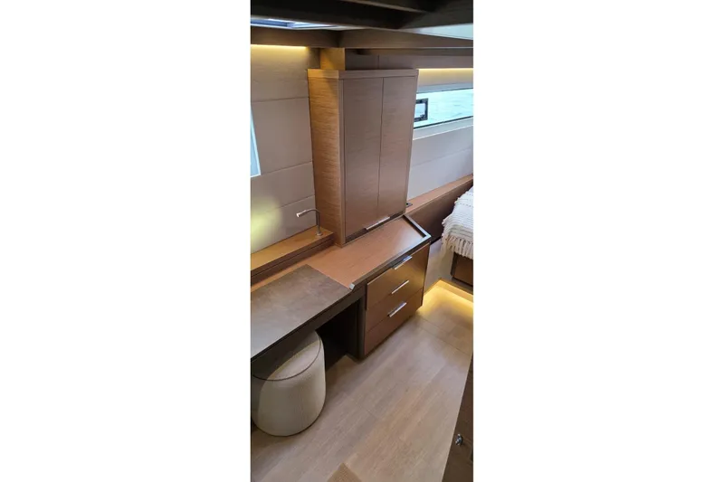 Slide: The Image of 2023 Lagoon 50 yacht interior with modern wood cabinetry and ambient lighting. - 81