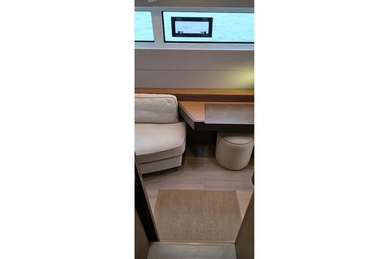 Slide: The Image of Interior of 2023 Lagoon 50 yacht with modern seating and window view. - 82
