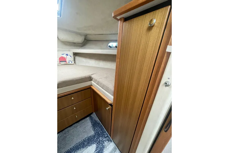 Slide: The Image of 2001 Bayliner 3388 Command Bridge Motoryacht cabin interior with wood cabinetry and cozy bedding. - 15