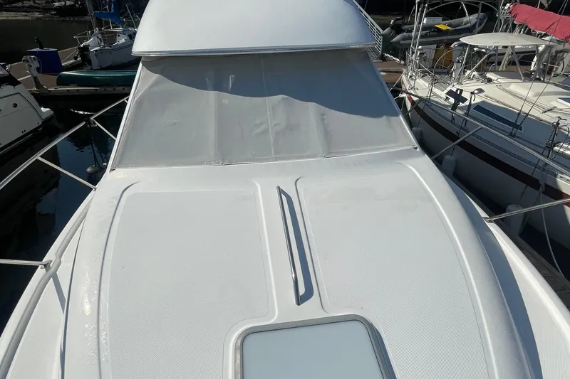 Slide: The Image of 2001 Bayliner 3388 Command Bridge Motoryacht docked, showcasing sleek design and spacious deck. - 17