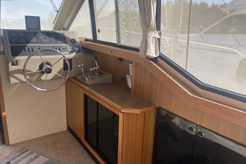 Slide: The Image of 2001 Bayliner 3388 Command Bridge Motoryacht helm with steering wheel and control panel. - 25