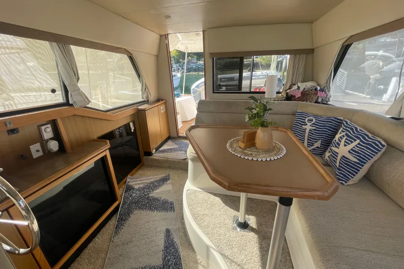 Slide: The Image of Interior of 2001 Bayliner 3388 Command Bridge Motoryacht with cozy seating and nautical decor. - 27