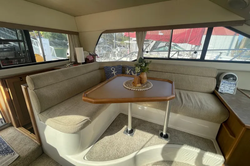 Slide: The Image of Interior of 2001 Bayliner 3388 Command Bridge Motoryacht with cozy seating and table. - 32
