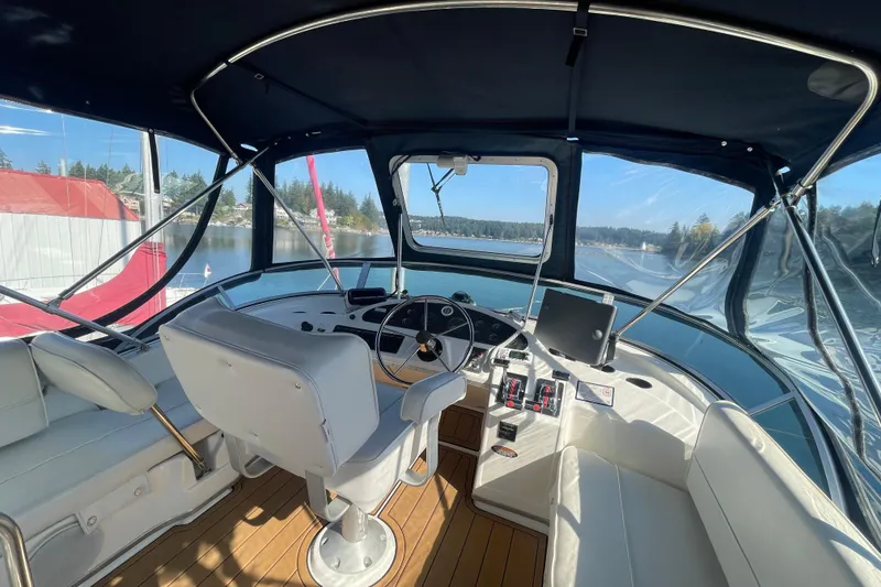 Slide: The Image of 2001 Bayliner 3388 Command Bridge Motoryacht helm with panoramic water view. - 33