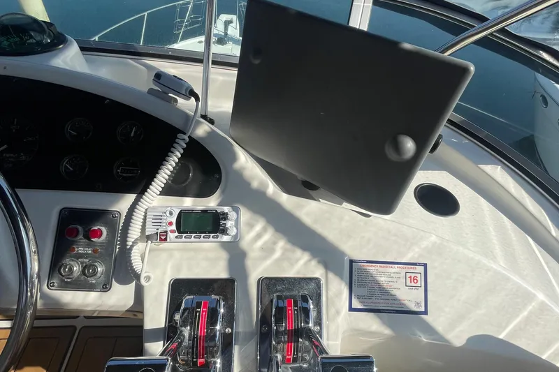 Slide: The Image of 2001 Bayliner 3388 Command Bridge Motoryacht helm with controls and navigation equipment. - 35