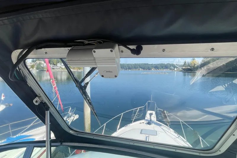 Slide: The Image of View from 2001 Bayliner 3388 Command Bridge Motoryacht, overlooking serene lake and distant shoreline. - 36