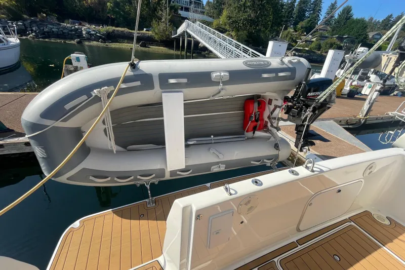 Slide: The Image of 2001 Bayliner 3388 Command Bridge Motoryacht with inflatable dinghy and outboard motor at dock. - 7